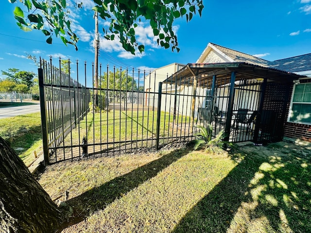 view of gate featuring a yard