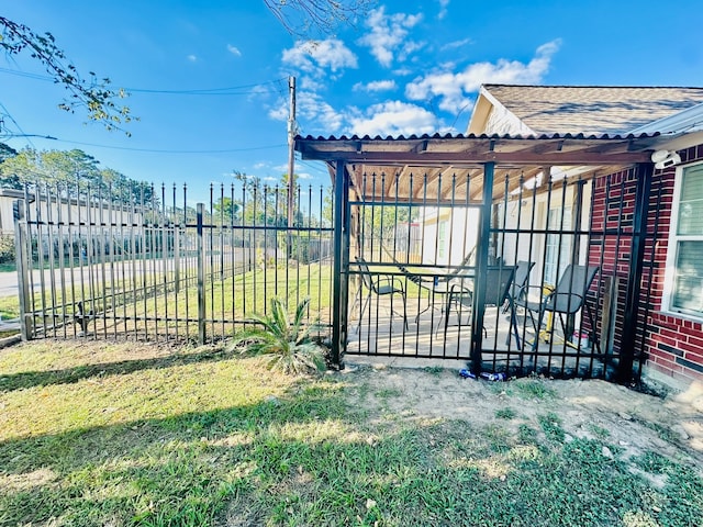 view of gate featuring a yard and a pergola