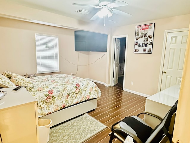 bedroom featuring connected bathroom, dark hardwood / wood-style floors, and ceiling fan