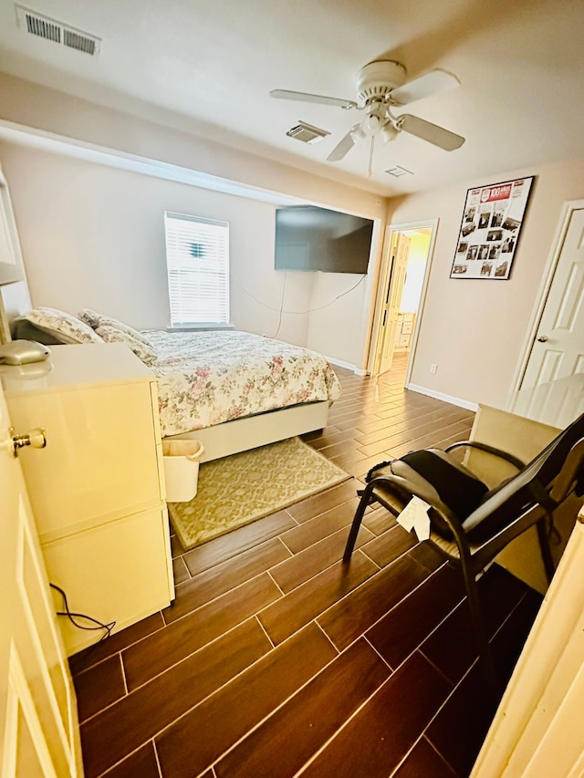 bedroom with ceiling fan and dark hardwood / wood-style floors