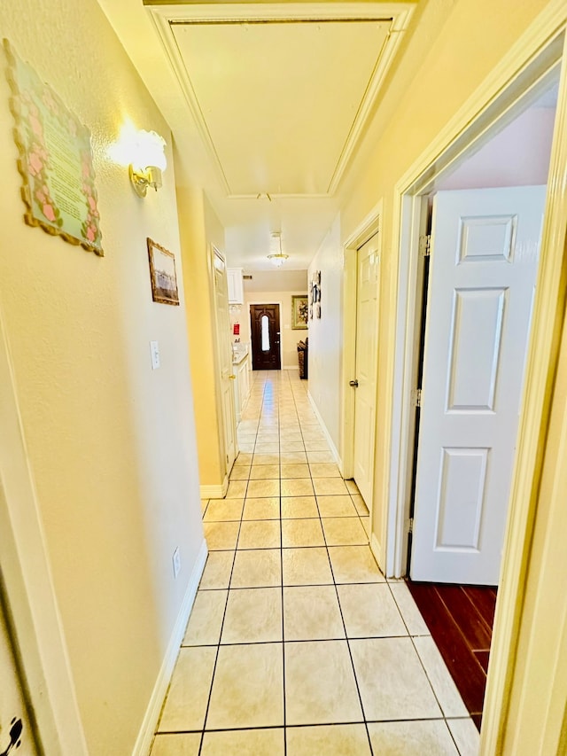 hall with light tile patterned floors