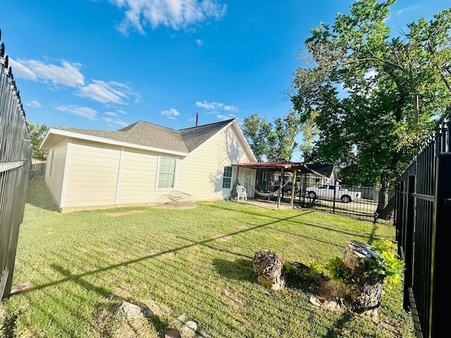 rear view of house featuring a yard