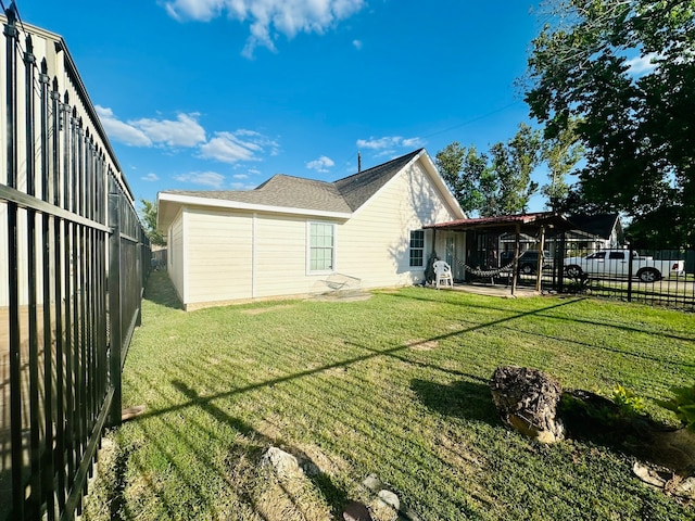 rear view of property featuring a patio and a yard