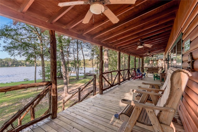 wooden deck with a water view and ceiling fan