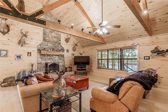 living room featuring beamed ceiling, wooden walls, and light hardwood / wood-style flooring