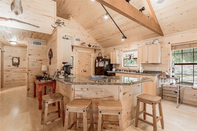 kitchen with wood ceiling, wooden walls, and freestanding refrigerator