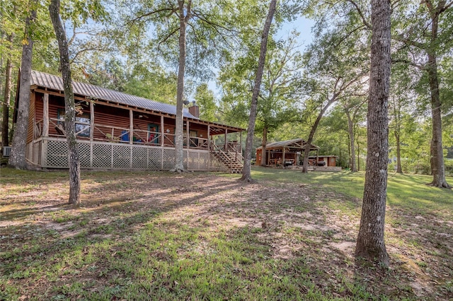 view of yard featuring a porch and stairway