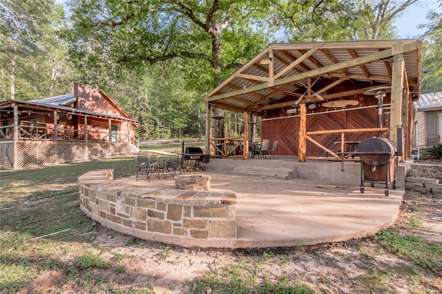 view of patio / terrace featuring an outbuilding, grilling area, and an outdoor fire pit