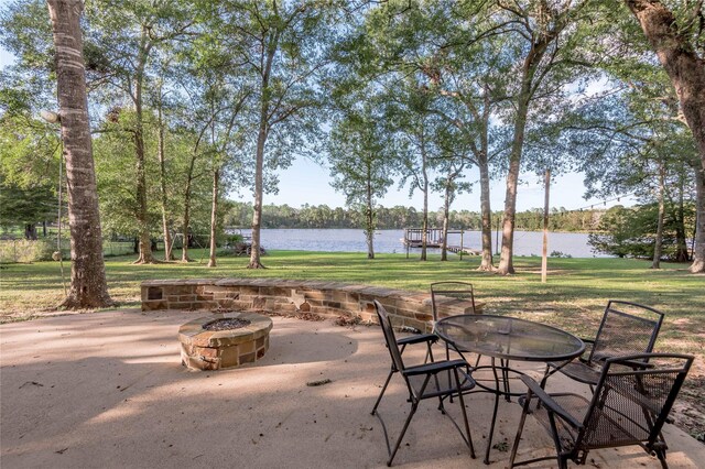 view of patio / terrace featuring an outdoor fire pit and a water view