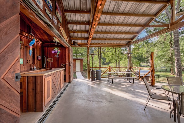 unfurnished sunroom with lofted ceiling with beams and a wealth of natural light