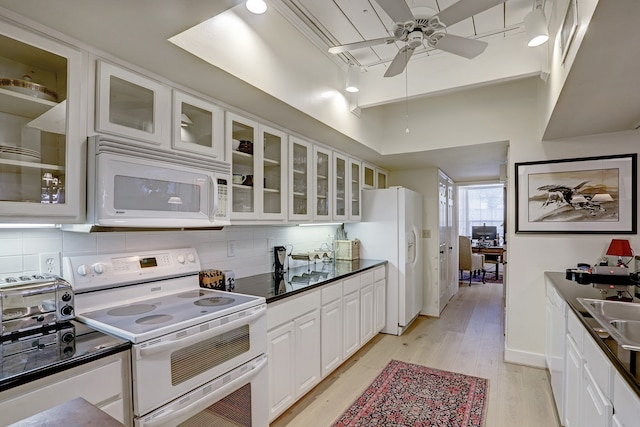 kitchen with light hardwood / wood-style floors, white cabinetry, backsplash, white appliances, and ceiling fan