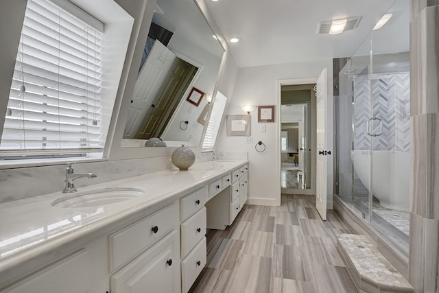 bathroom with vanity and a shower with shower door