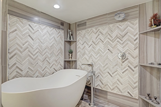 bathroom with tile walls and a tub