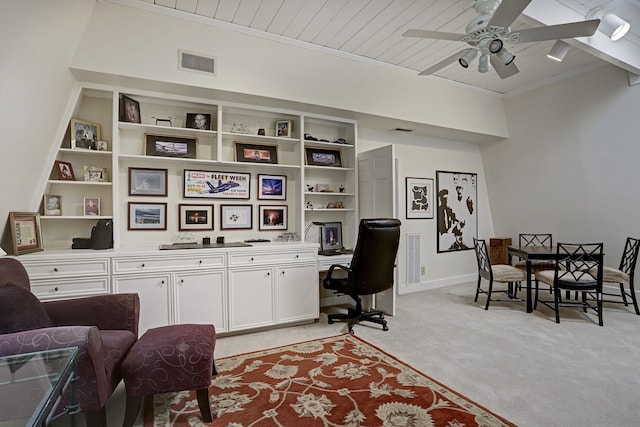 carpeted office space featuring ceiling fan, crown molding, and wooden ceiling