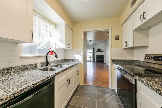 kitchen featuring a wealth of natural light, white cabinets, appliances with stainless steel finishes, and sink