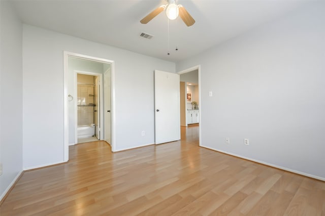 unfurnished bedroom featuring light wood-type flooring, ceiling fan, and connected bathroom