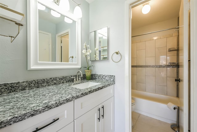 full bathroom featuring vanity, toilet, tile patterned floors, and tiled shower / bath