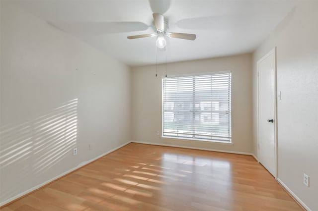 spare room featuring ceiling fan and light hardwood / wood-style floors