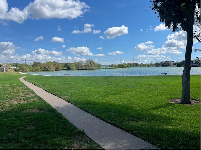 exterior space with a lawn and a water view