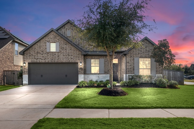 view of front of property featuring a lawn and a garage