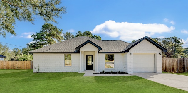 view of front of property featuring a garage and a front lawn