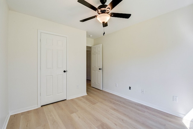 unfurnished bedroom featuring ceiling fan and light wood-type flooring