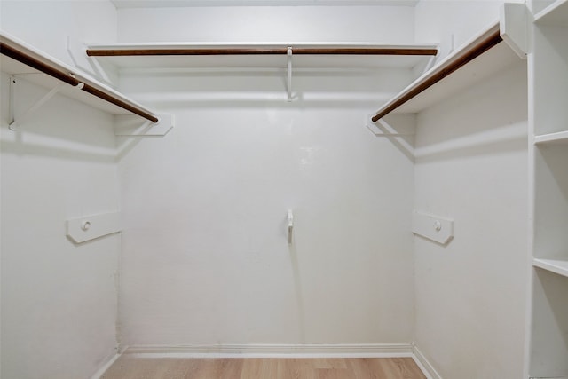 walk in closet featuring light hardwood / wood-style flooring