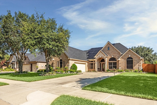 french country inspired facade featuring a front yard and a garage