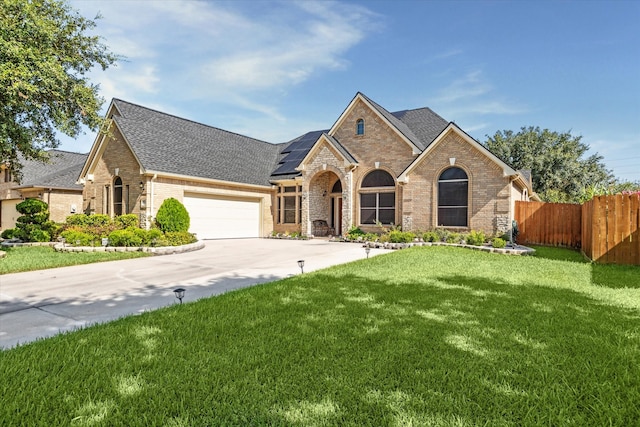 view of front of home with a garage and a front yard