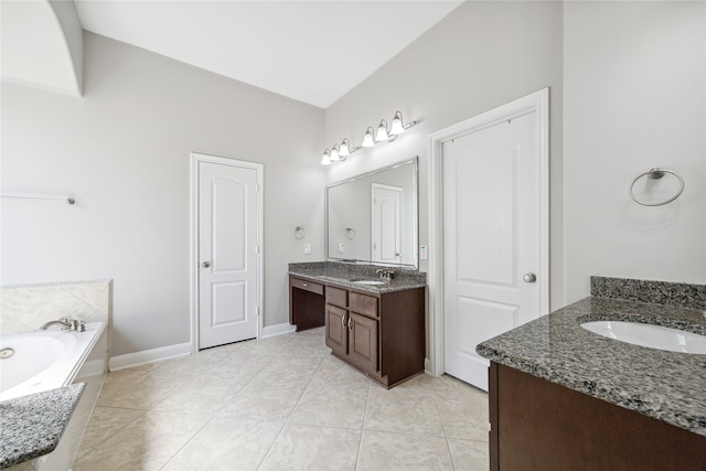 bathroom featuring vanity, tile patterned flooring, and a washtub