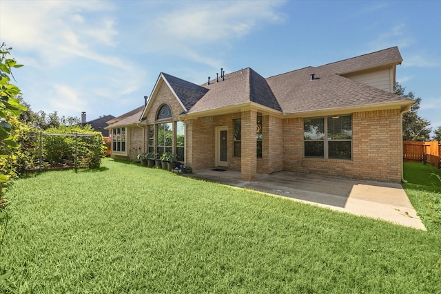 back of property featuring a lawn and a patio area