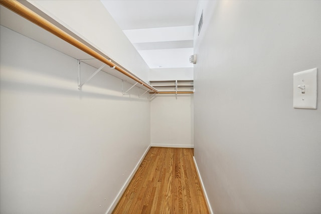 spacious closet featuring light hardwood / wood-style floors