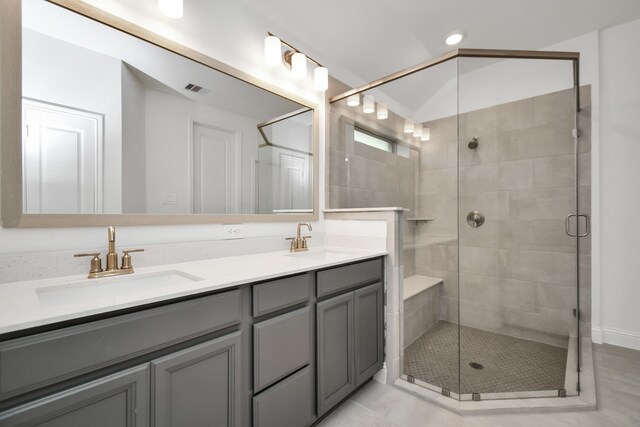 bathroom featuring vanity, a shower with shower door, and tile patterned floors