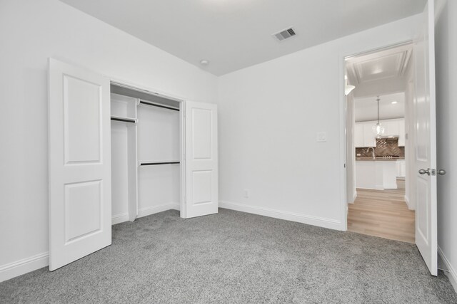 unfurnished bedroom with carpet and a closet