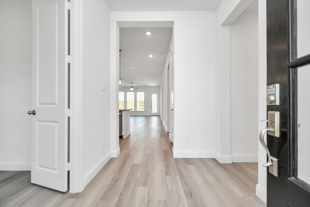 hallway with light hardwood / wood-style flooring