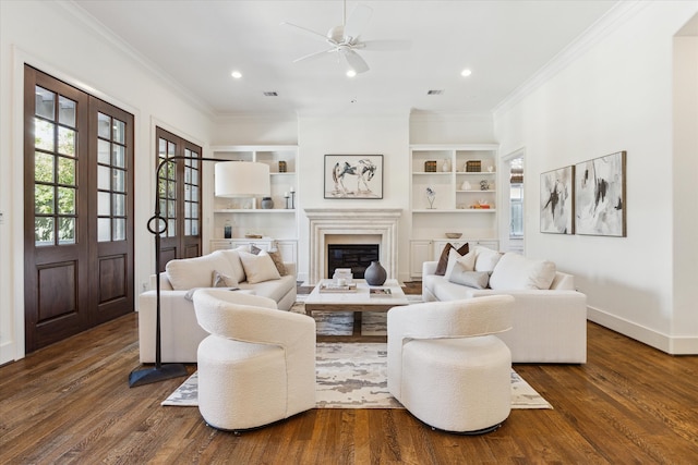 living room featuring ornamental molding, dark wood-type flooring, and ceiling fan