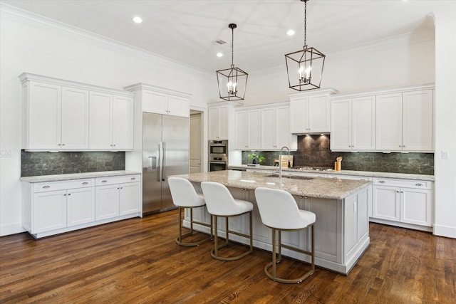 kitchen featuring a center island with sink, stainless steel appliances, dark hardwood / wood-style floors, and white cabinets