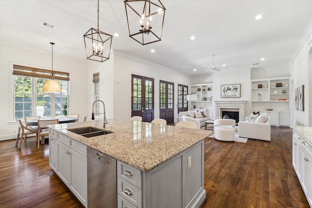 kitchen featuring dark hardwood / wood-style flooring, sink, stainless steel dishwasher, and a kitchen island with sink