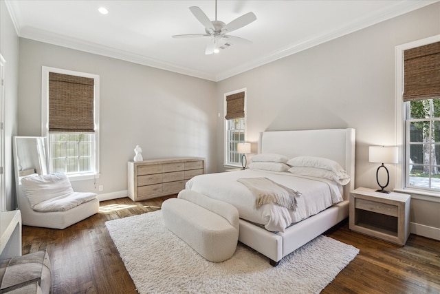 bedroom with ornamental molding, dark hardwood / wood-style floors, and ceiling fan