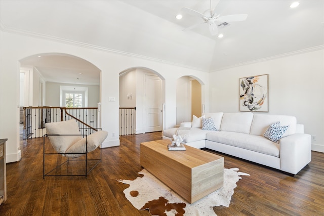 living room with crown molding, dark hardwood / wood-style floors, vaulted ceiling, and ceiling fan