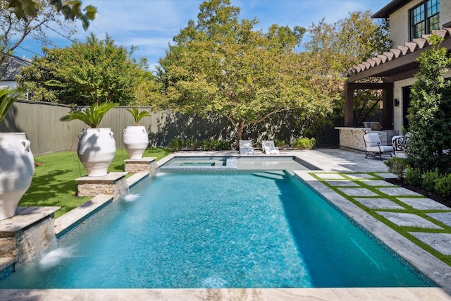 view of swimming pool with a patio and pool water feature