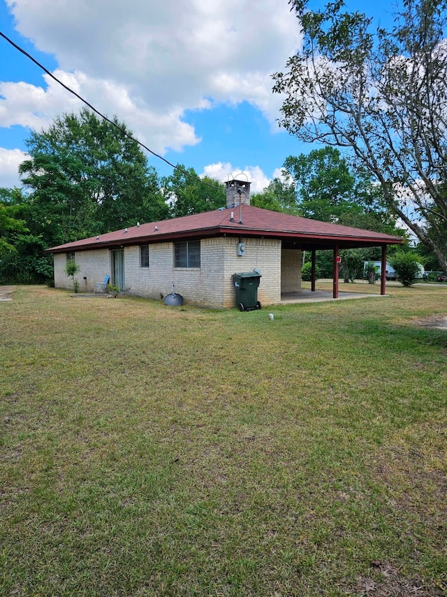 view of side of home with a patio area and a yard