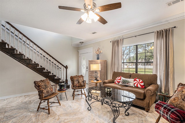 living room with ceiling fan and ornamental molding