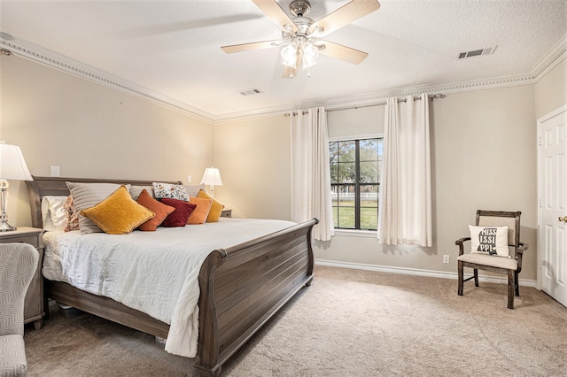 bedroom featuring carpet, ceiling fan, crown molding, and a textured ceiling