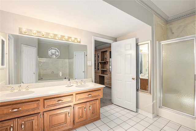 bathroom featuring tile patterned floors, vanity, a textured ceiling, and walk in shower