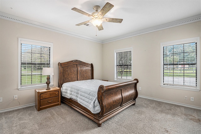 bedroom featuring ceiling fan, light carpet, and multiple windows