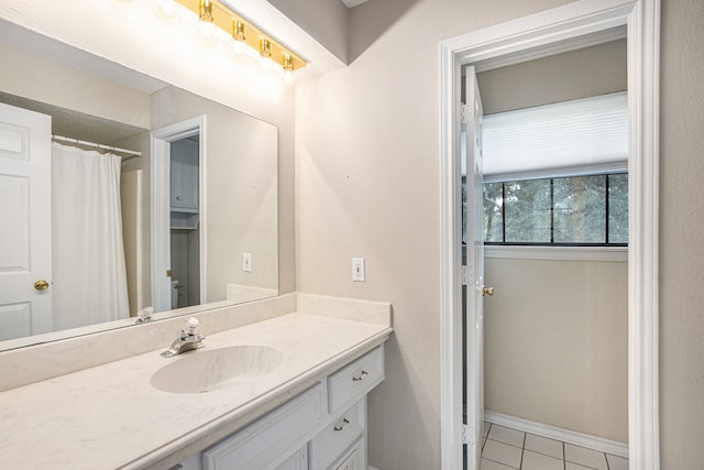 bathroom featuring tile patterned flooring and vanity