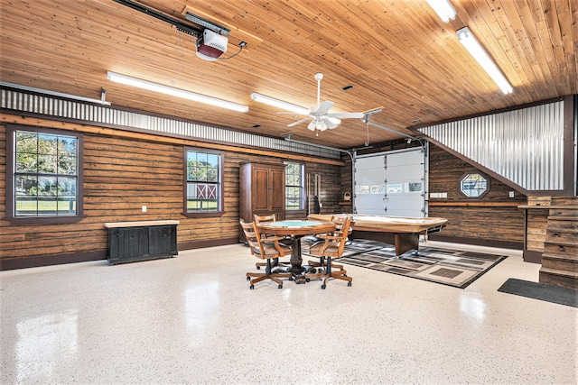 dining room with wooden ceiling, a healthy amount of sunlight, and wood walls