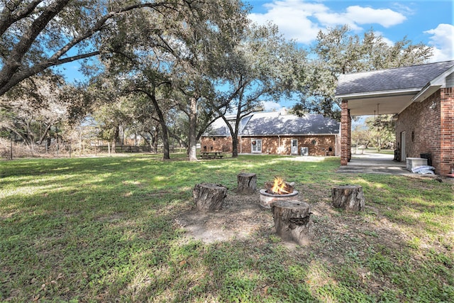 view of yard with an outdoor fire pit