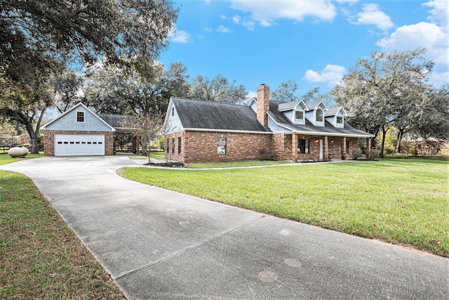 view of front of house featuring a garage, an outdoor structure, and a front lawn